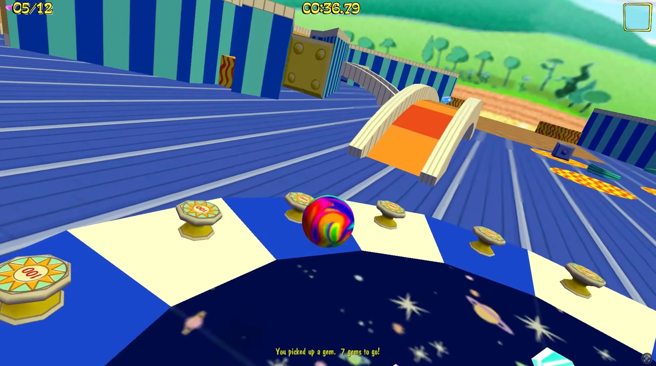 A marble rolling over a blue and white striped course with gems to collect